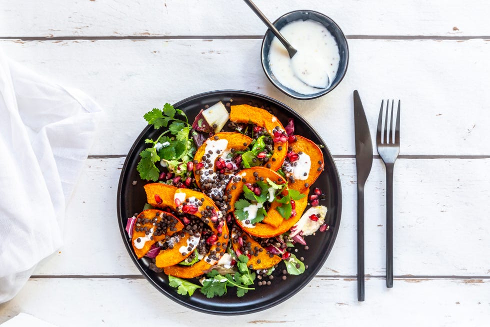 autumnal salad with fried pumpkin, lentils, radicchio, pomegranate seeds, leaf salad and parsley with dressing