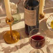 avaline red wine on table with candles, lemons, olive oil