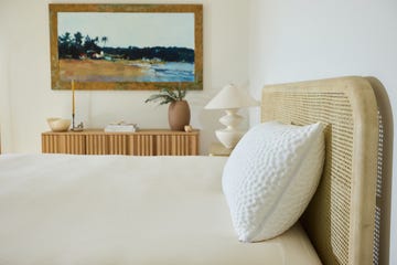 bedroom scene featuring a bed decorative elements and an artwork
