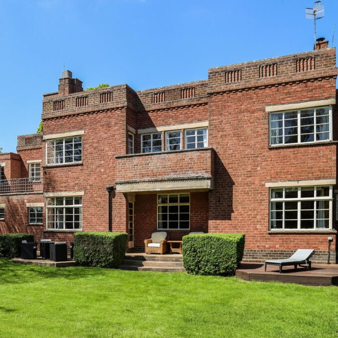a brick building with a lawn in front of it