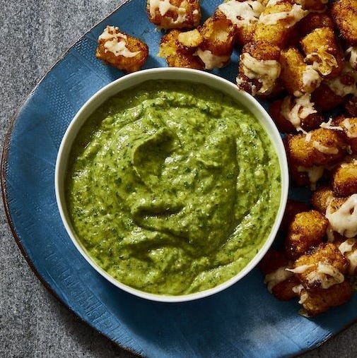 a bowl of green avocado dip