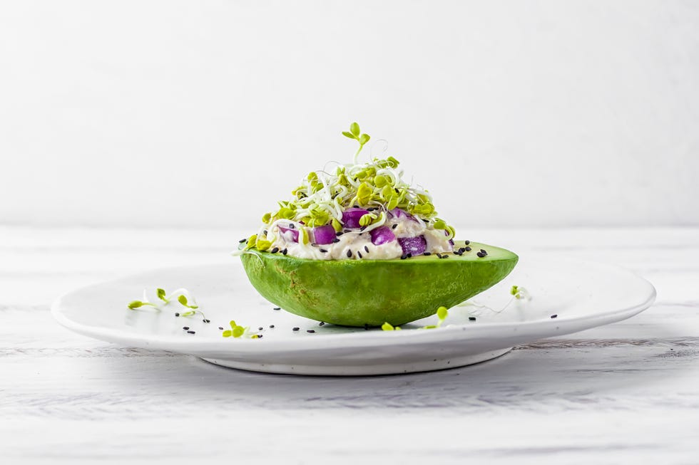 Avocado garden stuffed with tuna, mayonnaise, red onion, black sesame seeds and radish sprouts