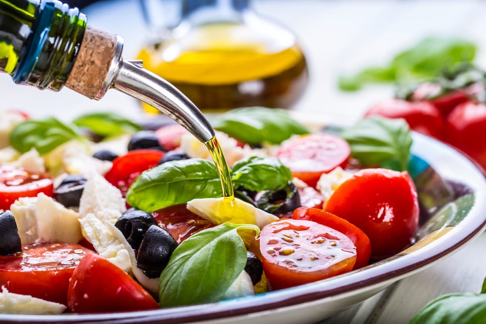 caprese caprese salad italian salad mediterranean salad italian cuisine mediterranean cuisine tomato mozzarella basil leaves black olives and olive oil on wooden table recipe ingredients