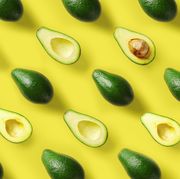 avocado pattern on yellow background pop art design, creative summer food concept green avocadoes, minimal flat lay style top view