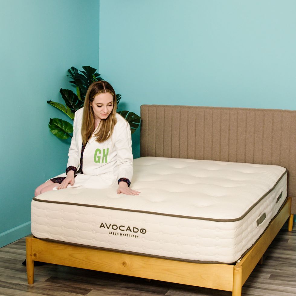 an analyst sits on the edge of the avocado green mattress