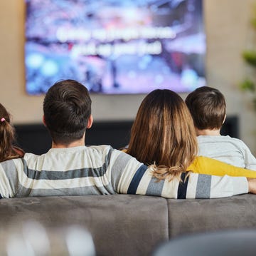 avoid paying the TV licence fee rear view of relaxed family watching tv on sofa in the living room