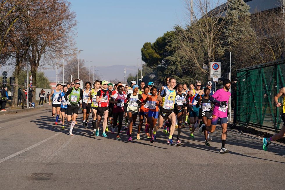 a group of people running on a street