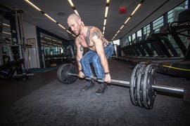 man doing deadlift in jeans