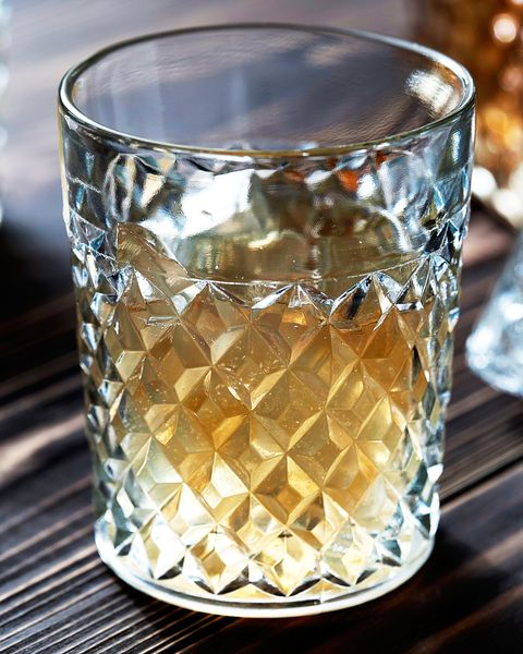 crystal decanter crystal glasses brandy, cognac whiskey with ice closeup