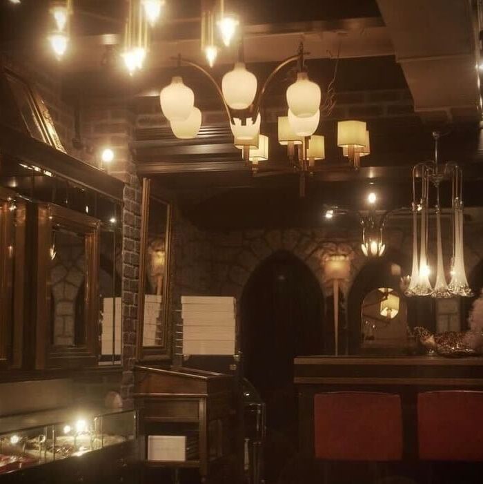 a bar with chandeliers