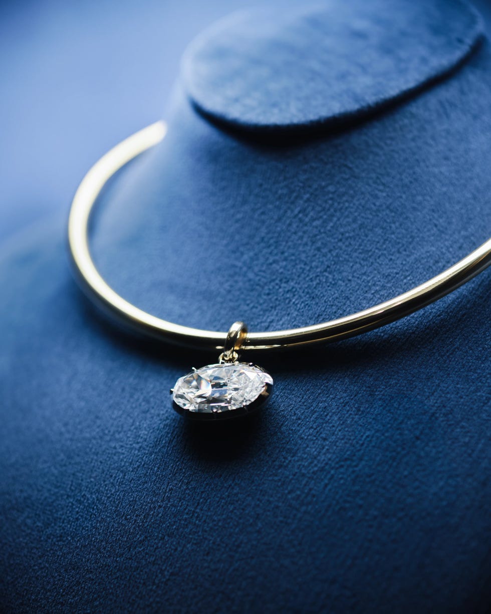 Elegant gold necklace with a large pendant.