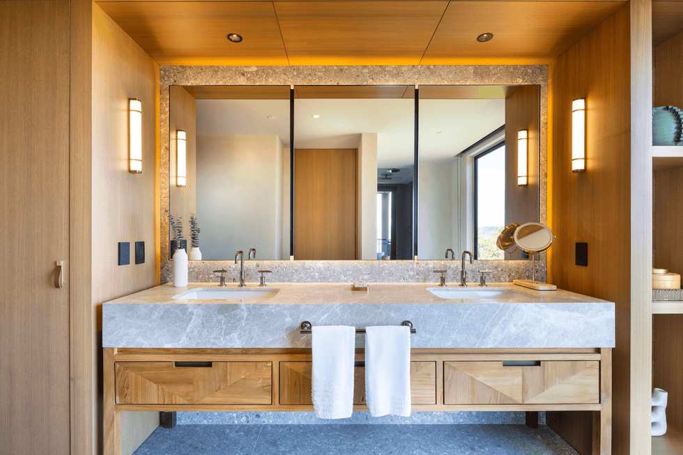 Modern bathroom with dual sinks and wood accents