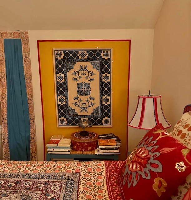 Cozy bedroom corner with patterned decor and books.