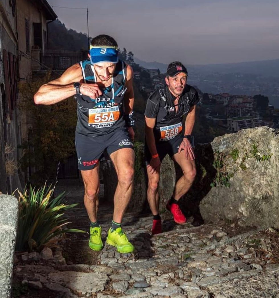 two men running on a rocky hill