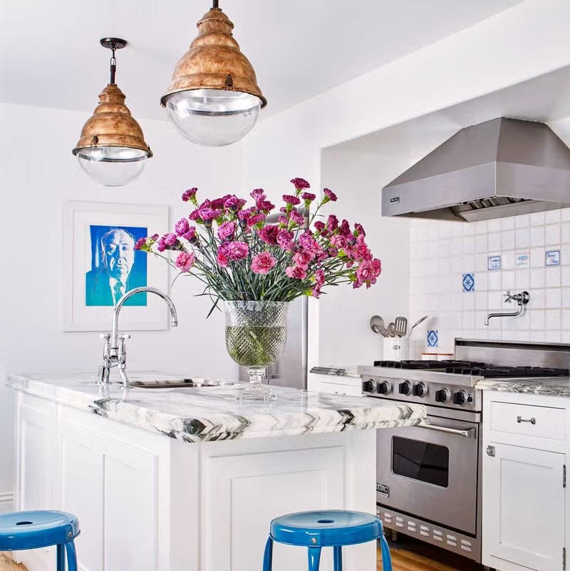 Modern kitchen with a floral centerpiece and stainless steel appliances