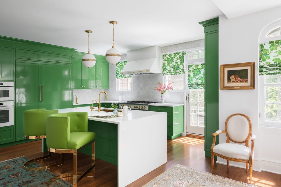 a kitchen with green cabinets