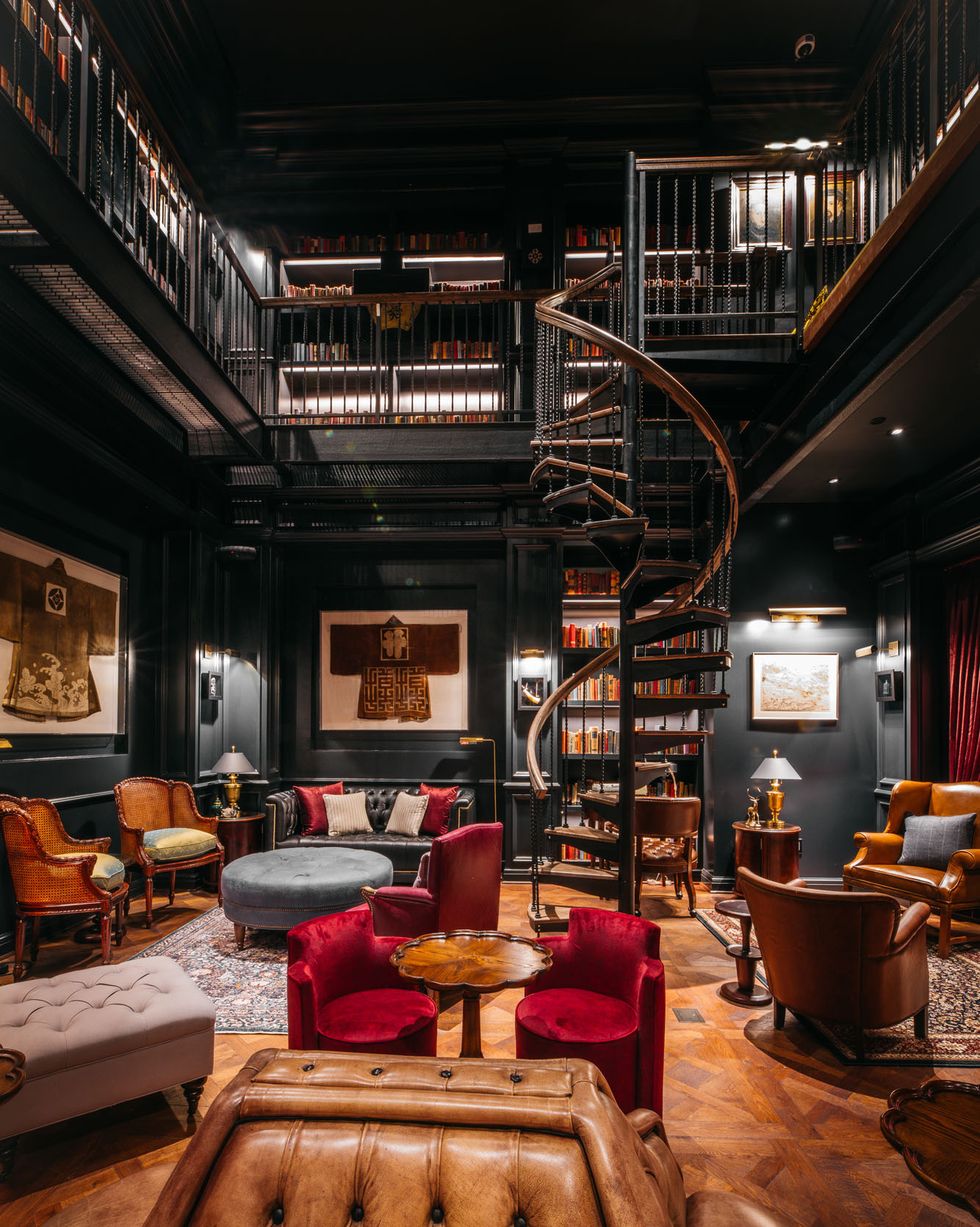 a room with a staircase and chairs