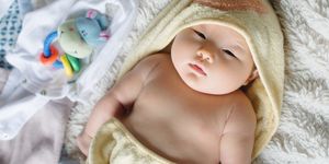 newborn baby in hooded bath towel