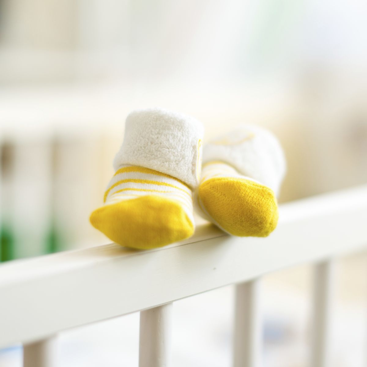 Baby booties on the edge of a cot