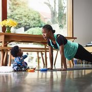 baby boy assisting mother exercising