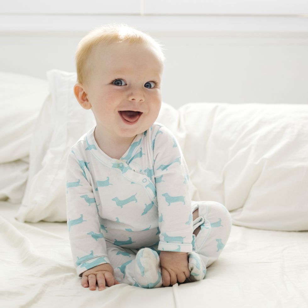 baby boy (6 11 months) lying on bed
