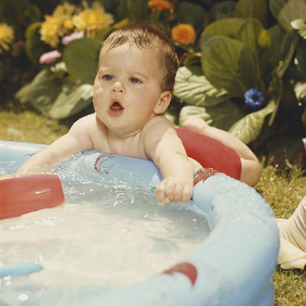 baby boy playing at wading pool
