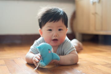 baby boy playing toy whale