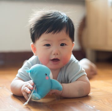 Middle Names for Boys baby boy playing toy whale