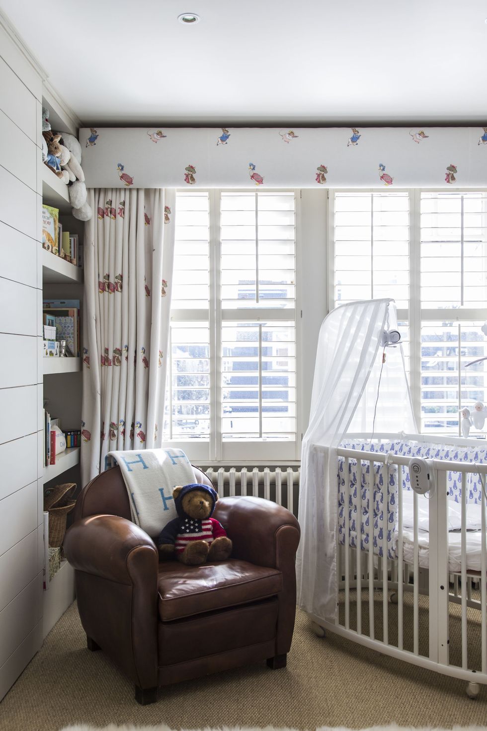 a baby in a chair in a room with a window