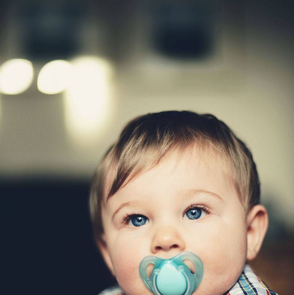 baby boy with pacifier in his mouth, portrait