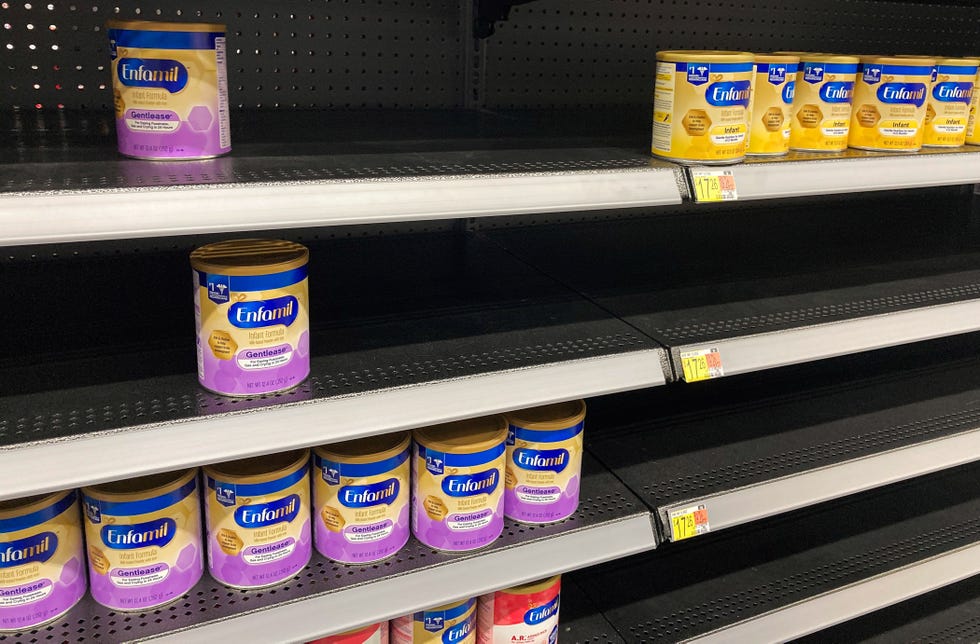 a baby formula display shelf is seen at a walmart grocery nearly empty