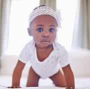 baby girl names that start with p  baby on hands and knees on bed