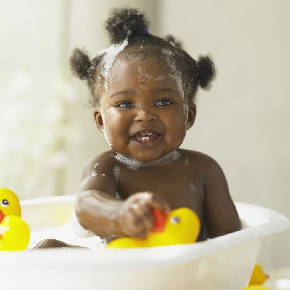 baby girl playing in the bathtub