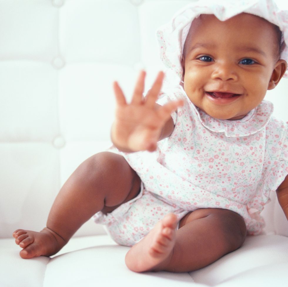 baby girl (9 12 months) reaching out