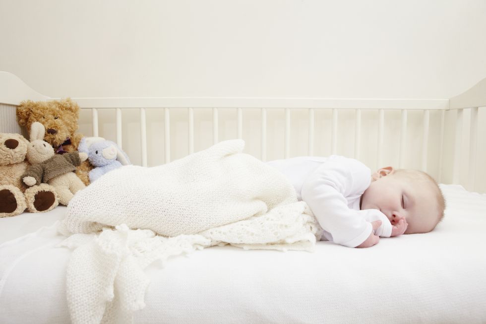 https://hips.hearstapps.com/hmg-prod/images/baby-girl-sleeping-in-crib-royalty-free-image-1636721403.jpg?crop=1xw:1xh;center,top&resize=980:*