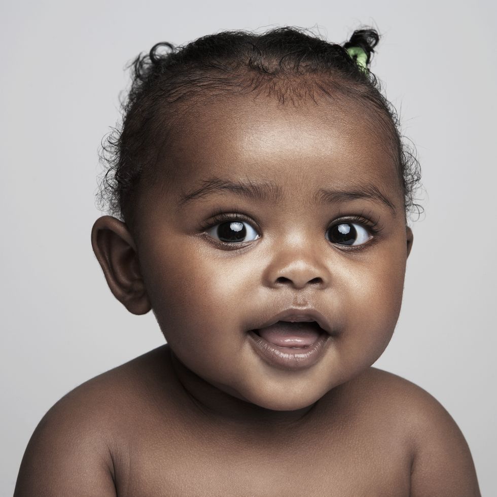 baby girl (6 9 months) smiling, portrait