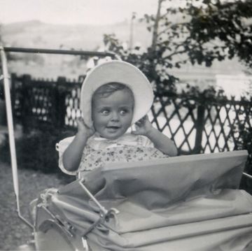 baby girl wearing sunhat and smiling