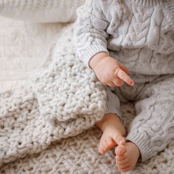 baby legs in gray cable knit romper