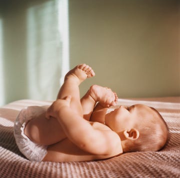 cute baby names baby laying on bed