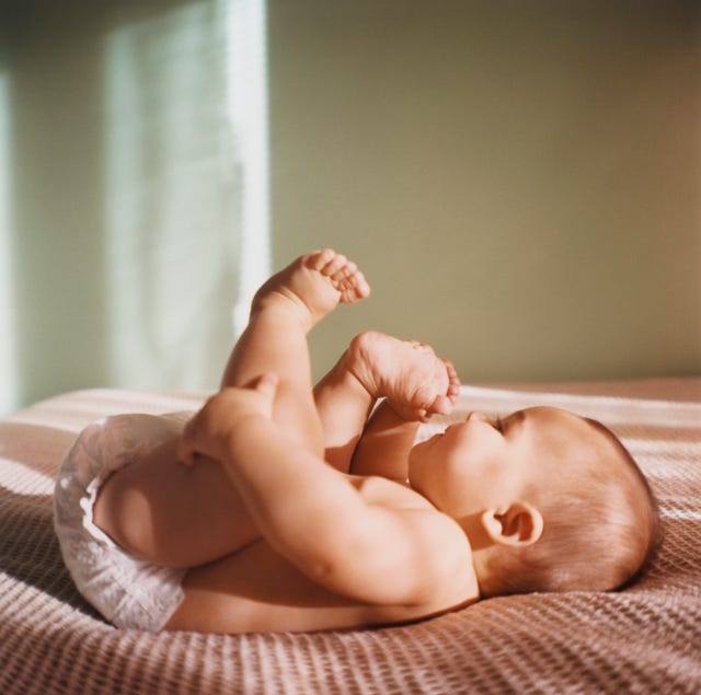 cute baby names baby laying on bed