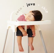 sleeping baby in a high chair