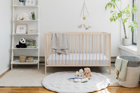 baby's room with crib and playmat