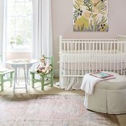 baby room with white crib green chairs and pink walls
