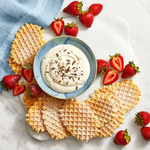 waffles surrounding a bowl of cannoli dip with strawberries, a great baby shower idea