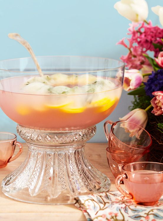 a pink punch in a fancy silver punch bowl that has a festive ice ring in it to keep it cold