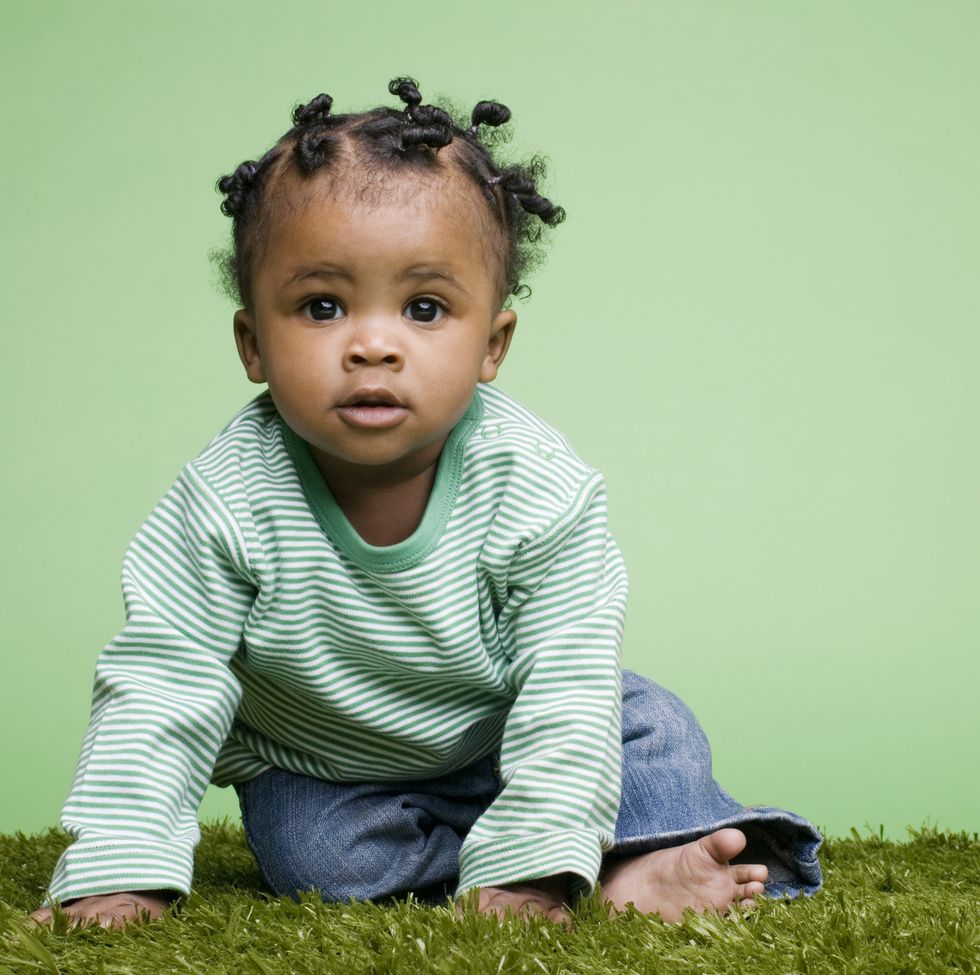 baby sitting on grass