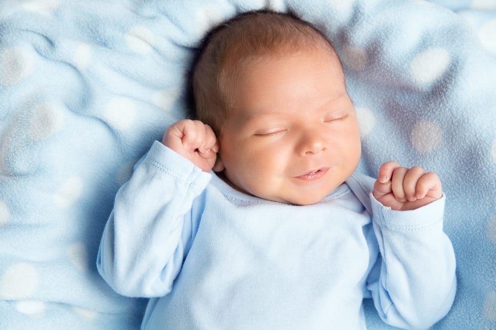 baby in blue shirt sleeping