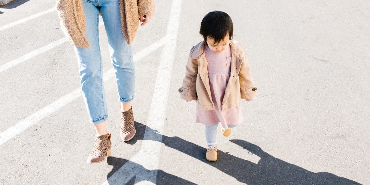 baby wearing shoes to walk with mom