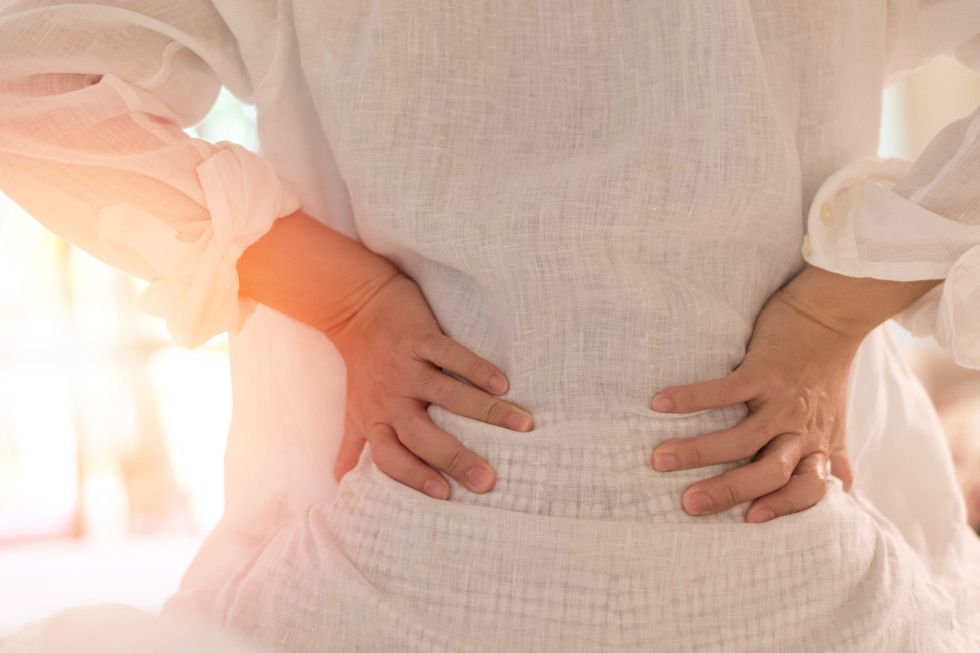 back pain in woman concept female patient hurt from lower backache from bowel and bladder problems, palvic inflammatory disease pid or motherhood pregnancy