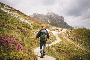 backpacker hikes trail in mountains